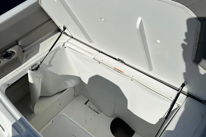Slide: The Image of Open storage compartment on 2022 Four Winns HD5 OB boat, showing interior space. - 23