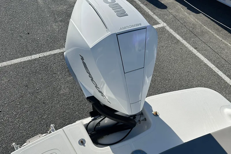 Slide: The Image of 2022 Four Winns HD5 OB boat with Mercury outboard engine in parking lot. - 24