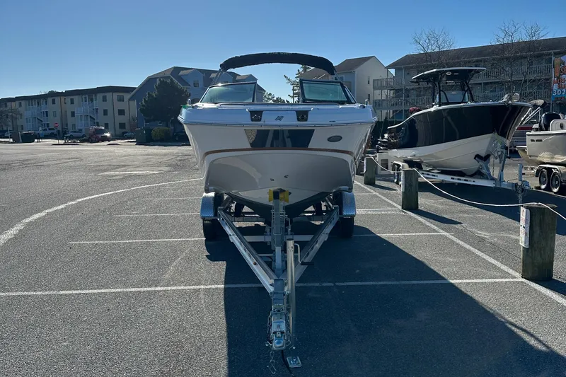 Slide: The Image of 2022 Four Winns HD5 OB boat on trailer in parking lot, sunny day. - 3