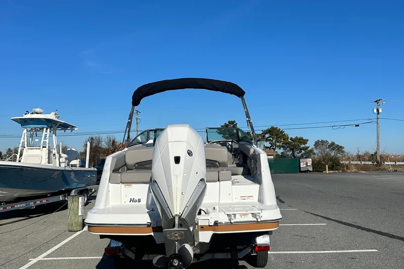 Slide: The Image of 2022 Four Winns HD5 OB boat with outboard motor in parking lot. - 7