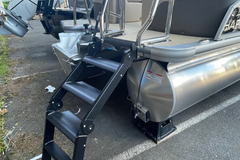 Slide: The Image of 2026 Harris Cruiser 210 CW pontoon boat with rear ladder and aluminum pontoons. - 10
