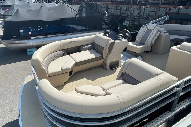 Slide: The Image of 2026 Harris Cruiser 210 CW pontoon boat with luxurious seating and modern design. - 2