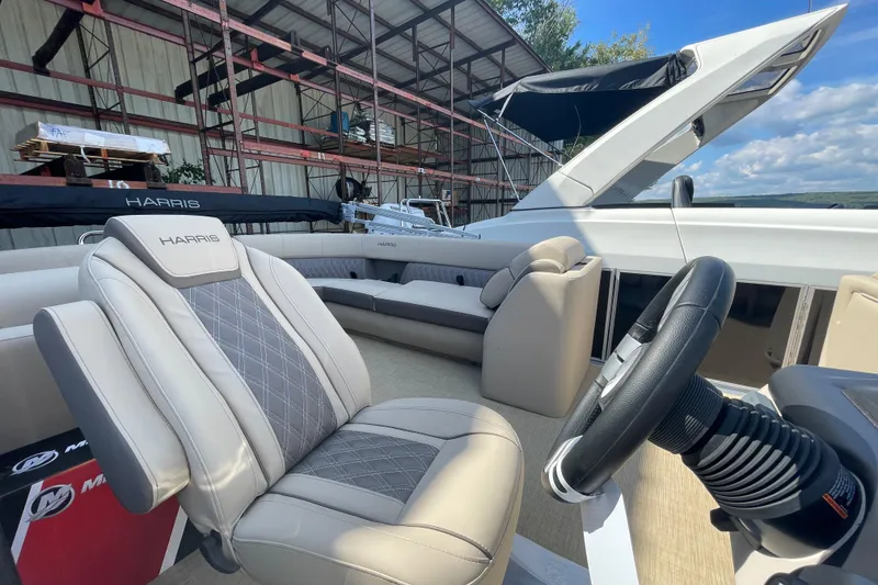 Slide: The Image of 2026 Harris Cruiser 210 CW interior with luxurious seating and modern steering wheel. - 6