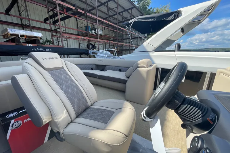 Slide: The Image of 2026 Harris Cruiser 210 CW boat interior with luxurious seating and steering wheel. - 7