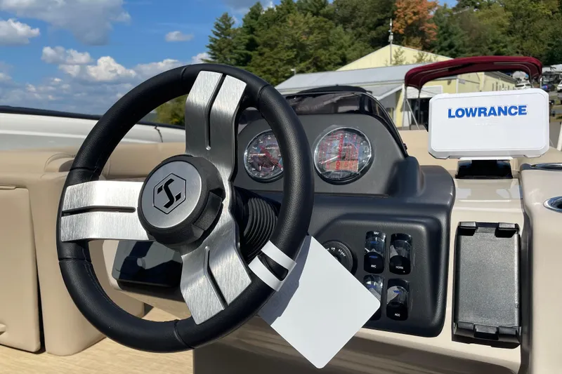 Slide: The Image of 2026 Harris Cruiser 210 CW dashboard with steering wheel and Lowrance navigation system. - 8