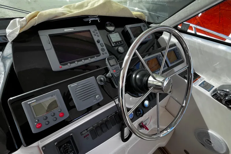 Slide: The Image of 2009 Tiara Yachts 3900 Open helm with advanced navigation equipment and steering wheel. - 11