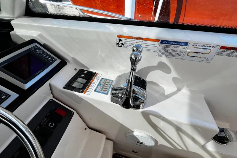 Slide: The Image of 2009 Tiara Yachts 3900 Open helm controls with navigation display and throttle lever. - 12