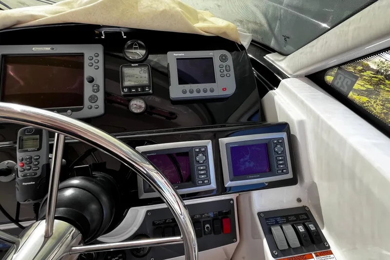 Slide: The Image of Dashboard of 2009 Tiara Yachts 3900 Open with navigation and control instruments. - 13