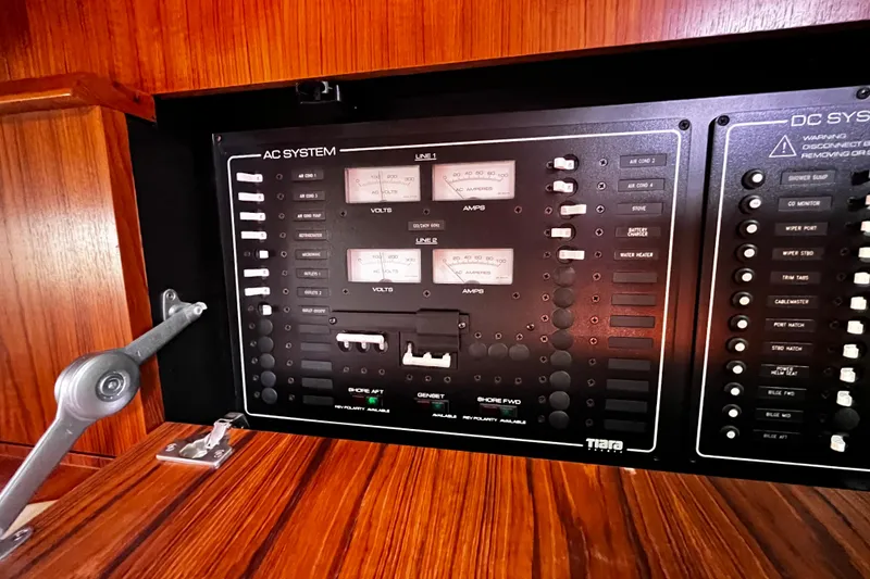 Slide: The Image of Electrical control panel on a 2009 Tiara Yachts 3900 Open, featuring AC and DC systems. - 16