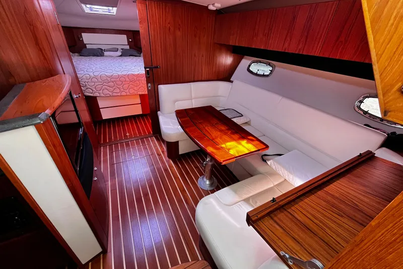 Slide: The Image of Luxurious interior of 2009 Tiara Yachts 3900 Open with wood finishes and cozy seating. - 18