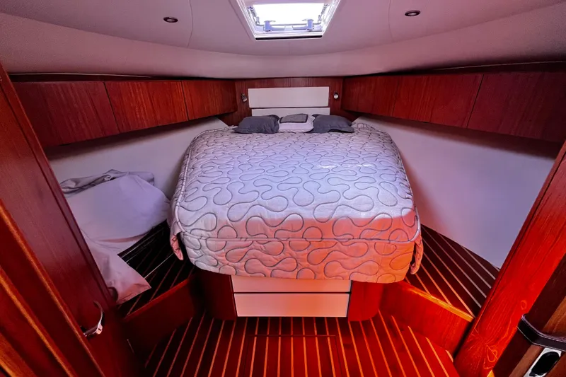 Slide: The Image of Luxurious cabin interior of 2009 Tiara Yachts 3900 Open with cozy bed and wooden accents. - 22