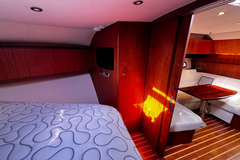 Slide: The Image of Luxurious interior of 2009 Tiara Yachts 3900 Open with wood accents and cozy seating area. - 23