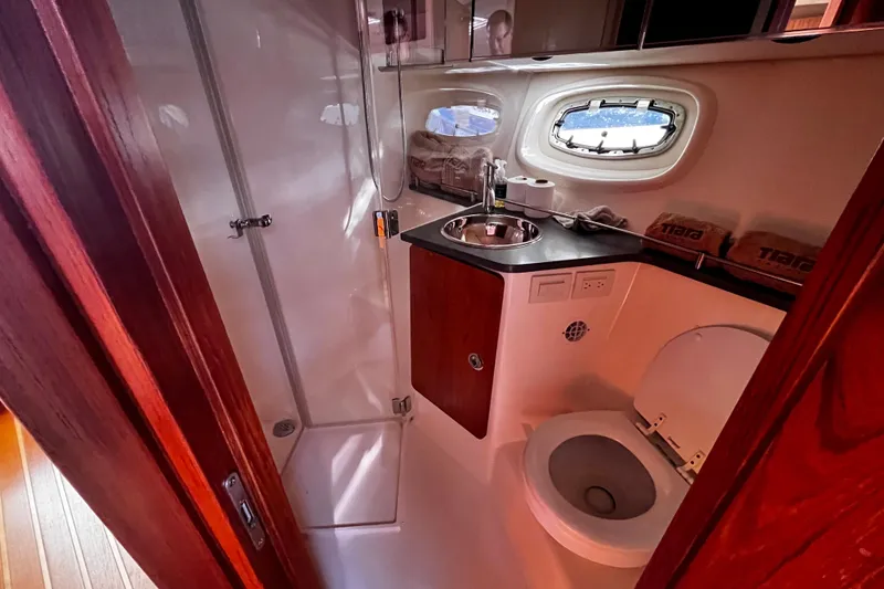 Slide: The Image of 2009 Tiara Yachts 3900 Open bathroom with shower, sink, and toilet. - 25