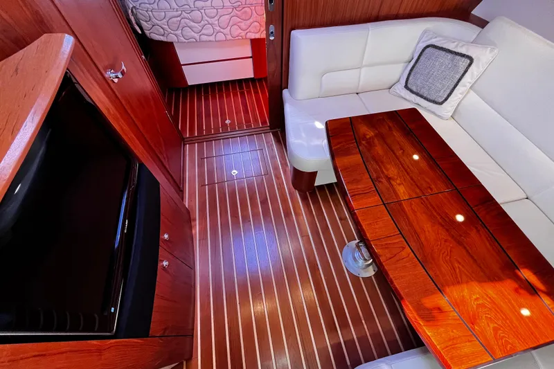 Slide: The Image of Luxurious interior of 2009 Tiara Yachts 3900 Open with wood flooring and plush seating. - 27