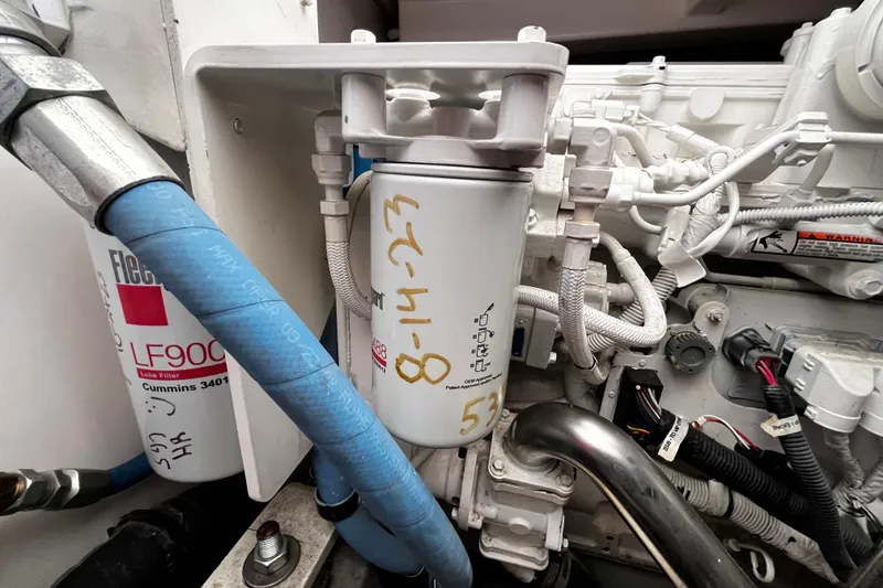 Slide: The Image of Engine compartment of a 2009 Tiara Yachts 3900 Open, featuring filters and hoses. - 28