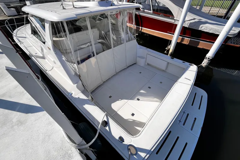 Slide: The Image of 2009 Tiara Yachts 3900 Open docked, showcasing spacious deck and sleek design. - 4