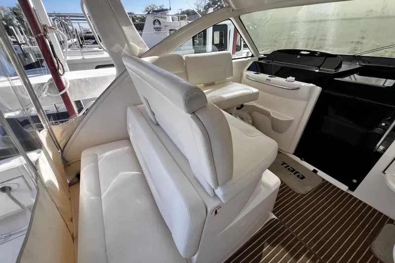 Slide: The Image of 2009 Tiara Yachts 3900 Open interior with white seating and helm station. - 7