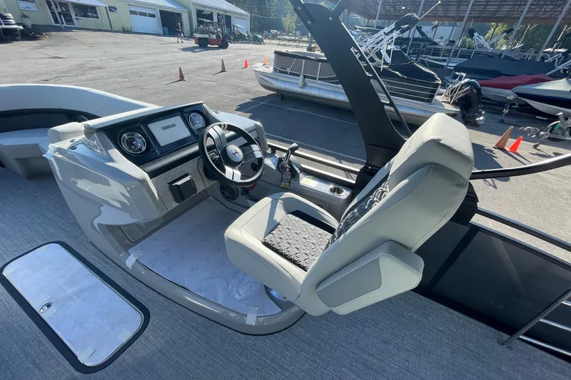 Slide: The Image of 2026 Harris Solstice 230SLDH boat interior with steering wheel and dashboard. - 10