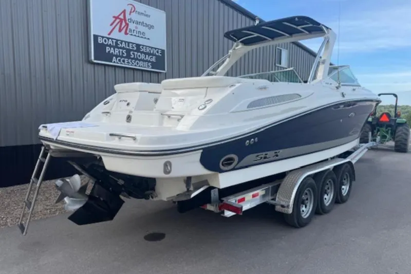Slide: The Image of 2008 Sea Ray 270 SLX boat on trailer at marine dealership. - 0