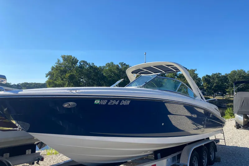 Slide: The Image of 2008 Sea Ray 270 SLX boat on trailer under clear blue sky. - 1