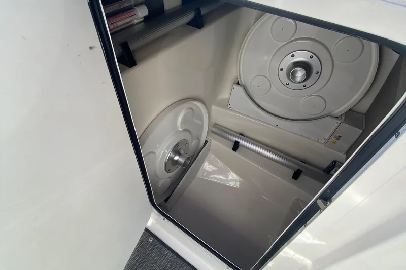 Slide: The Image of Storage compartment in a 2008 Sea Ray 270 SLX boat, featuring circular components. - 12