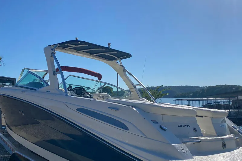 Slide: The Image of 2008 Sea Ray 270 SLX boat docked under clear blue sky. - 2