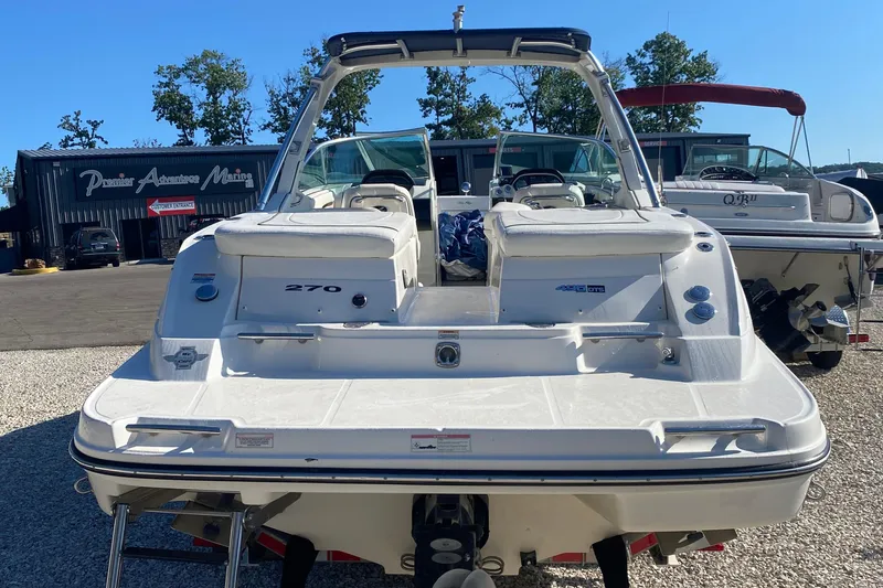 Slide: The Image of 2008 Sea Ray 270 SLX boat at marina, rear view with seating and controls. - 3