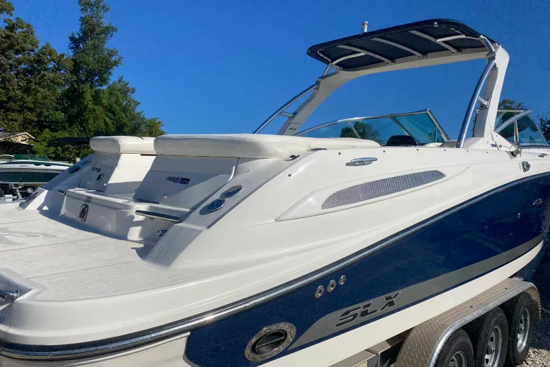 Slide: The Image of 2008 Sea Ray 270 SLX boat with sleek design, docked outdoors. - 4