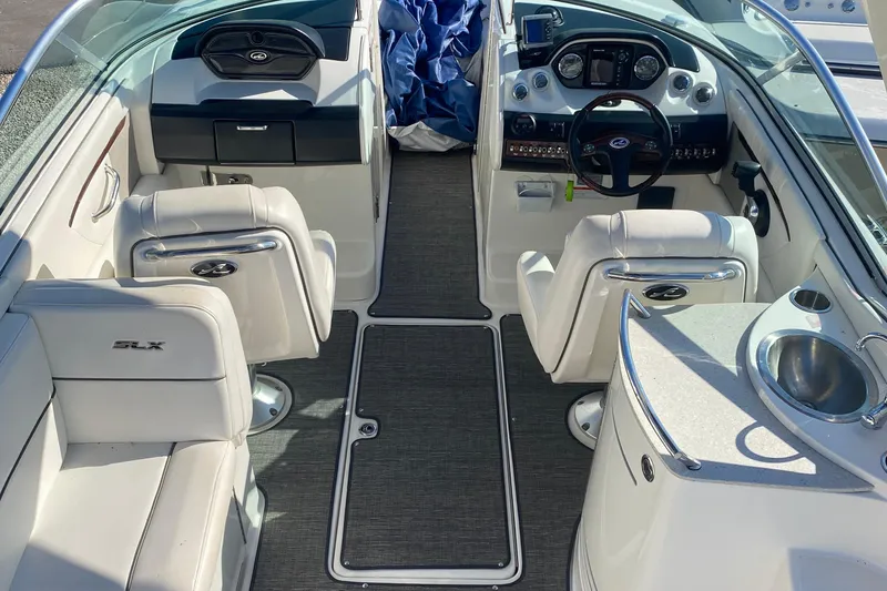 Slide: The Image of 2008 Sea Ray 270 SLX boat interior with white seating, steering console, and sink. - 5
