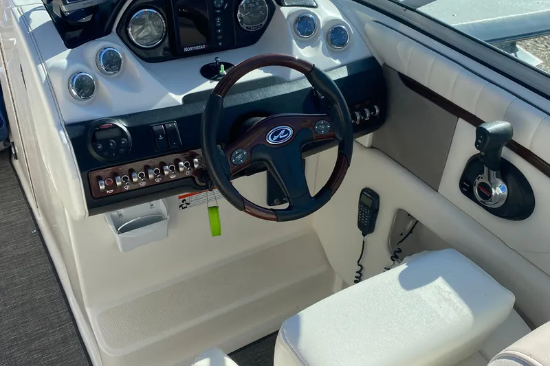 Slide: The Image of 2008 Sea Ray 270 SLX boat dashboard with steering wheel and controls. - 9