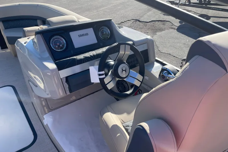 Slide: The Image of 2026 Harris Grand Mariner 230 SL boat dashboard with steering wheel and controls. - 10