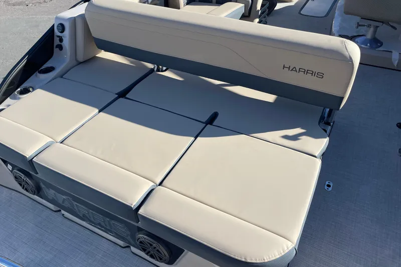 Slide: The Image of 2026 Harris Grand Mariner 230 SL boat seating, beige upholstery, cup holders, and speaker system. - 13