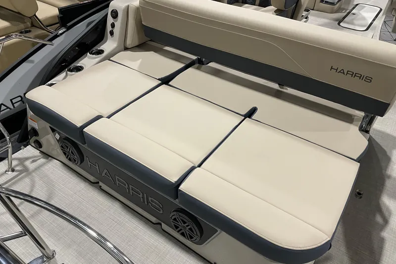 Slide: The Image of 2026 Harris Grand Mariner 230 SL boat interior with beige seating and speaker system. - 17