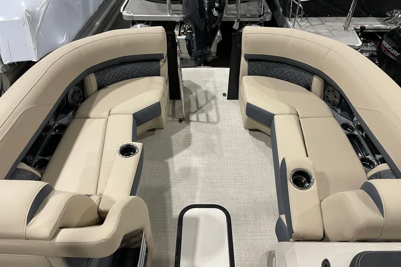 Slide: The Image of Luxurious seating on 2026 Harris Grand Mariner 230 SL pontoon boat, featuring beige upholstery and cup holders. - 19