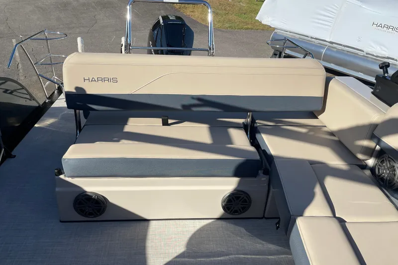 Slide: The Image of 2026 Harris Grand Mariner 230 SL boat interior with beige seating and speaker system. - 6