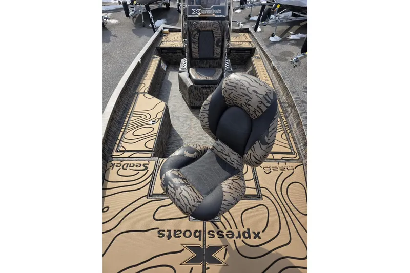 Slide: The Image of 2026 Xpress H22B Bay boat interior with patterned seats and deck design. - 13