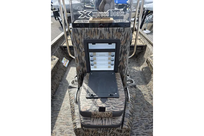 Slide: The Image of 2026 Xpress H22B Bay boat interior with camouflage design and storage compartment. - 15