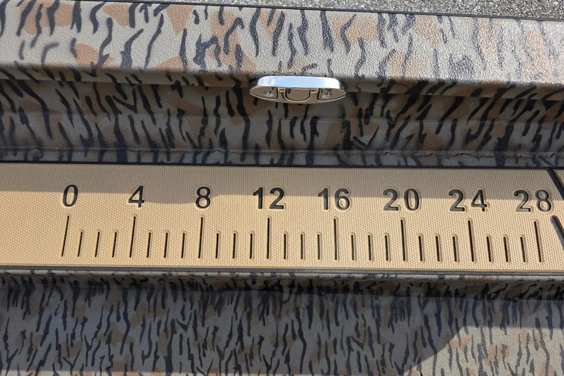 Slide: The Image of Camouflage-patterned Xpress H22B Bay boat with built-in measuring ruler, 2026 model. - 18