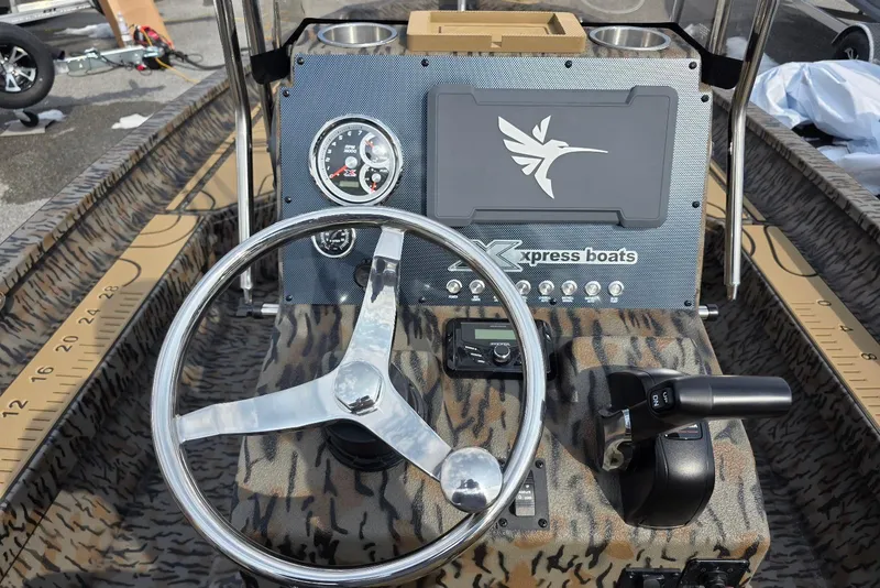 Slide: The Image of 2026 Xpress H22B Bay boat dashboard with steering wheel and control panel. - 19