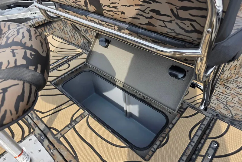 Slide: The Image of 2026 Xpress H22B Bay boat interior with open storage compartment and patterned seating. - 23