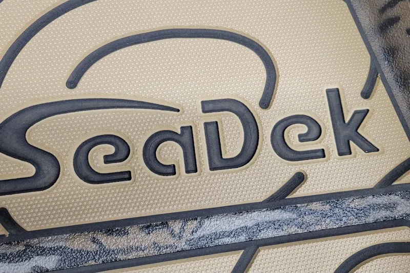 Slide: The Image of SeaDek logo on textured surface, featured in 2026 Xpress H22B Bay boat. - 6