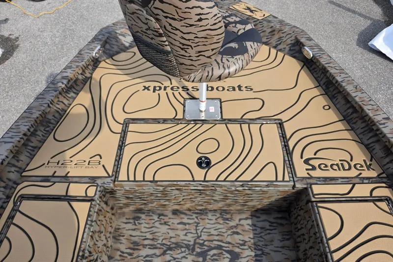 Slide: The Image of 2026 Xpress H22B Bay boat deck with SeaDek flooring and camouflage pattern. - 9