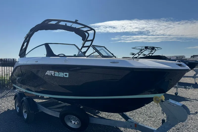 Slide: The Image of 2026 Yamaha Boats AR220 on trailer under clear blue sky. - 3