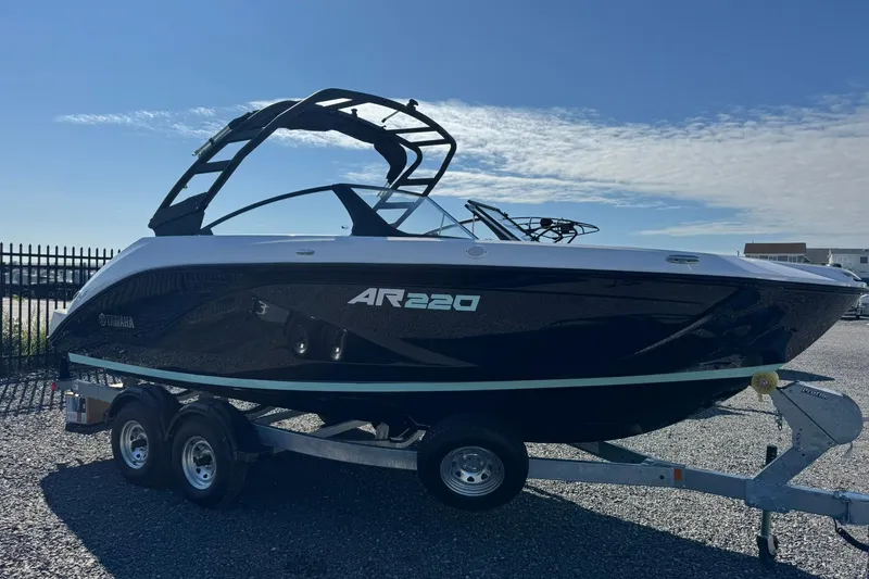 Slide: The Image of 2026 Yamaha Boats AR220 on trailer, sleek design under clear blue sky. - 4