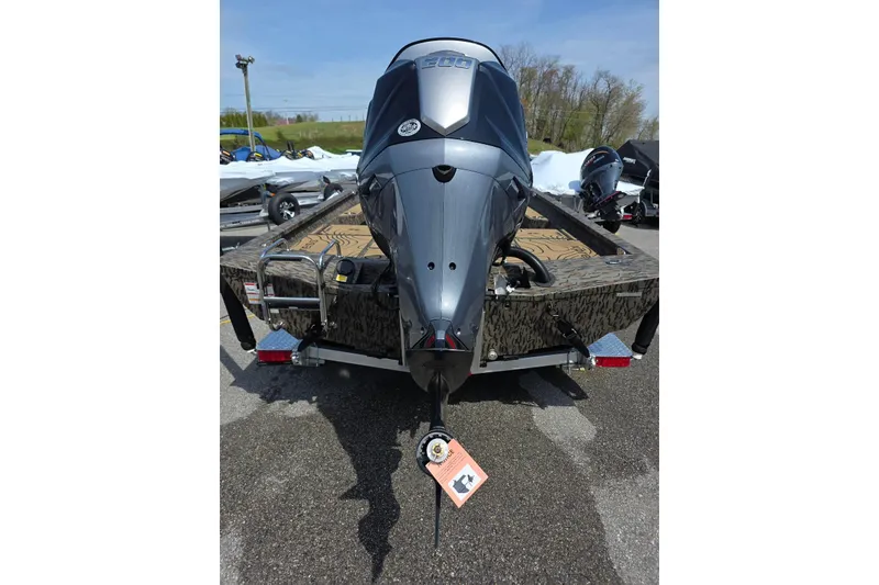 Slide: The Image of 2026 Xpress H22B Bay boat with powerful outboard motor, parked outdoors. - 13