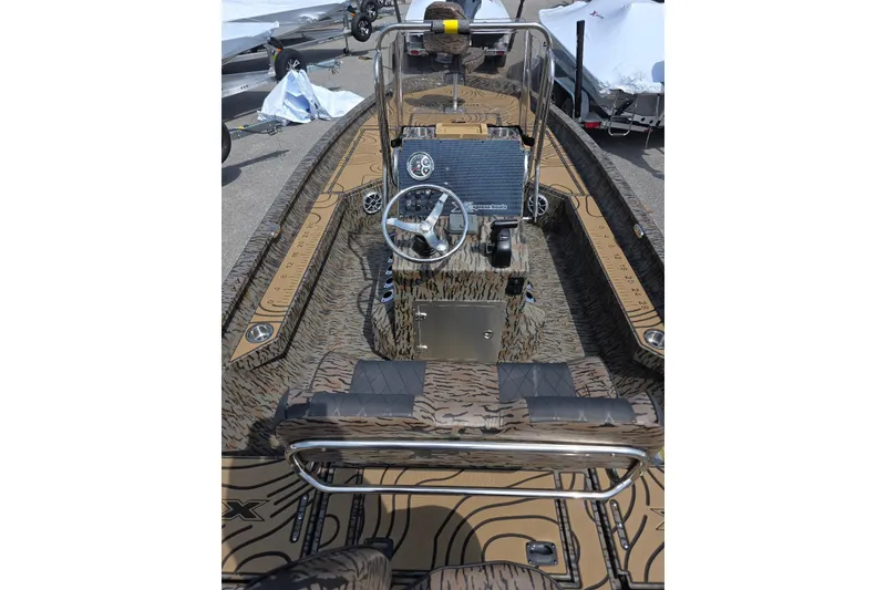 Slide: The Image of 2026 Xpress H22B Bay boat interior with camouflage design and steering console. - 14