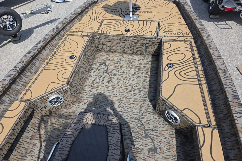 Slide: The Image of 2026 Xpress H22B Bay boat interior with custom SeaDek flooring and camouflage design. - 15