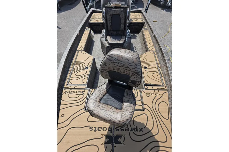 Slide: The Image of 2026 Xpress H22B Bay boat interior with patterned seating and deck design. - 19