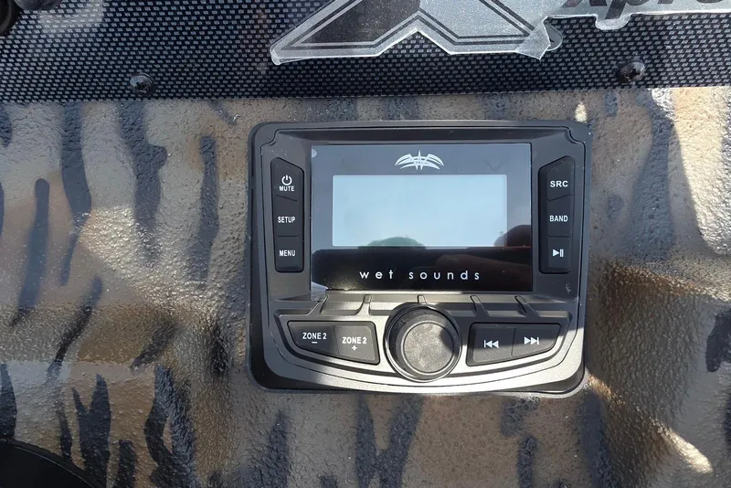 Slide: The Image of Control panel of a 2026 Xpress H22B Bay boat featuring a Wet Sounds audio system. - 27