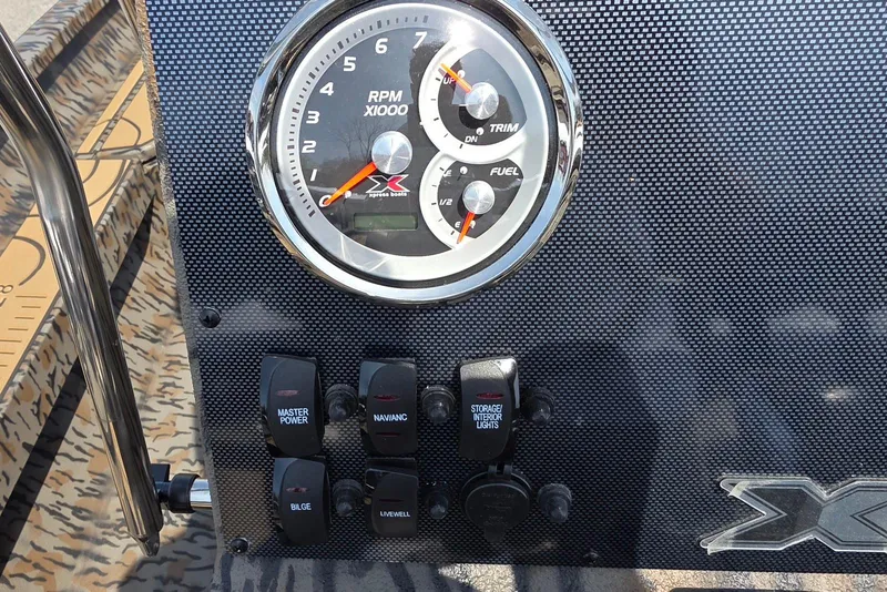 Slide: The Image of Dashboard of 2026 Xpress H22B Bay boat with gauges and control switches. - 28